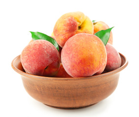 Ripe peaches in bowl isolated on white