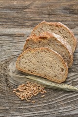 Rustic bread and wheat on an old wood table