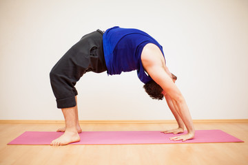 Backbend pose by a young man