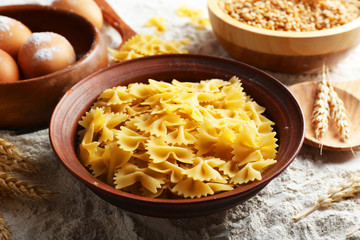 Preparing pasta with white flour and wheat on table, closeup