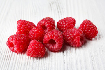 Fresh red raspberries on wooden background