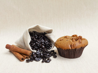 Coffee muffin and coffee bean with cinnamon on canvas background