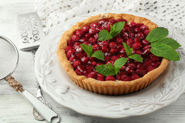 Tart with raspberries, on wooden background