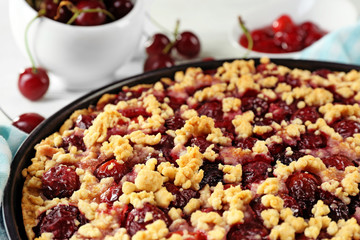 Tasty homemade pie with cherries on table close up
