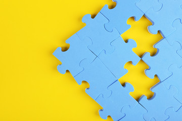 Puzzle pieces on yellow background