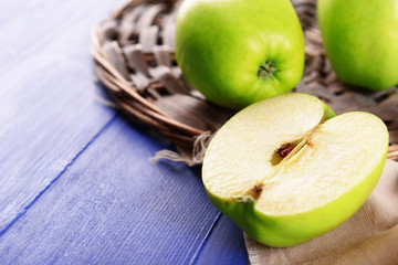 Sliced green apple on wooden table, closeup