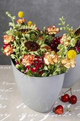 Floral arrangement with carnations and craspedias