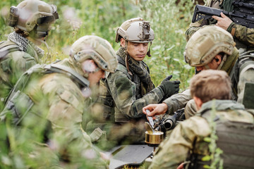 rangers are heated food on the fire and eat in the forest