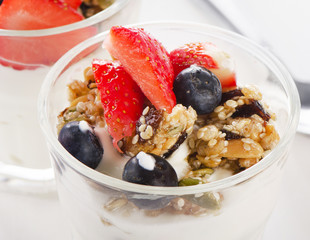 Granola with yogurt and berries in  glass.