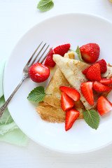 crepes with slices of strawberries