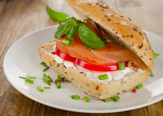 Sandwich with cereals bread and salmon on  old wooden table.