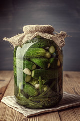 Jar of pickles on wooden table