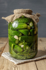 Jar of pickles on wooden table