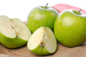 Fresh green apples on burlap