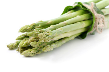 Fresh green asparagus on white