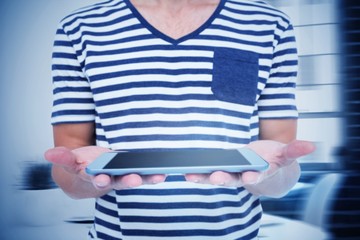 Composite image of close up of man holding tablet