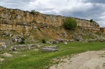 General view toward crag of sedimentary rock in the field, Ludogorie, Bulgaria  
