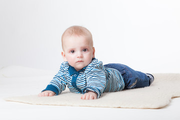 Cheerful baby in fashionable clothes on a white background