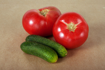Two ripe tomatos and two cucumbers