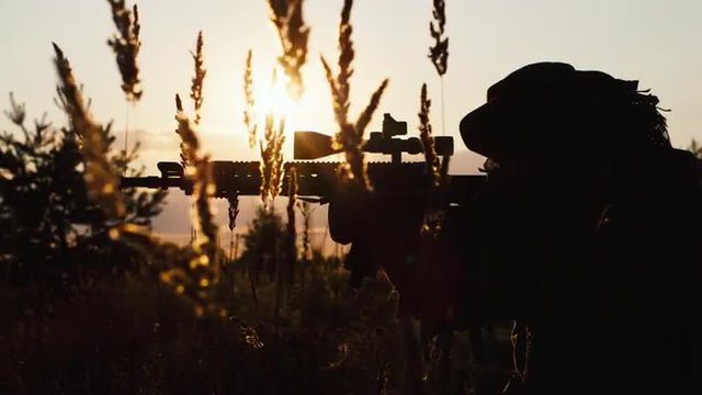 Silhouette of a soldier who takes aim