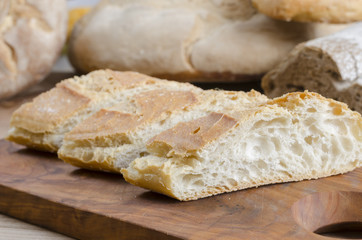 Obraz na płótnie Canvas Sliced bread on an olive wooden board.