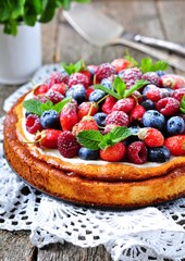 Cottage cheese casserole with fresh strawberries, blueberries, raspberries and mint and powdered sugar