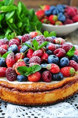 Cottage cheese casserole with fresh strawberries, blueberries, raspberries and mint and powdered sugar
