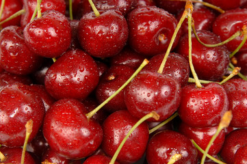 Background of ripe sweet cherry with drops and splashes water