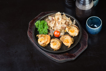 japanese cuisine. grilled shell fish on the background