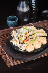 japanese cuisine. hot plate sea food on the background