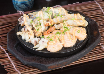 japanese cuisine. hot plate sea food on the background
