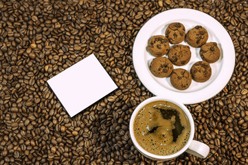 Coffee bean background with cup of fresh hot coffee and plate fu