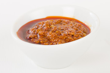 Chilli Dip - Naga chilli sauce in a white bowl on a white background.