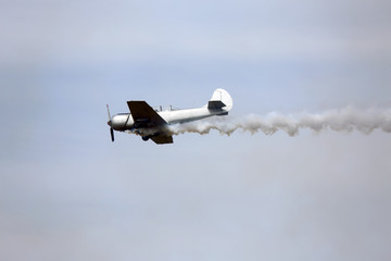 historic warplane with dark smoke from the engine malfunction