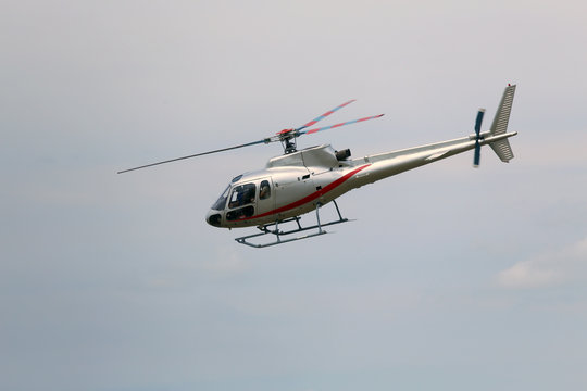 civil helicopter flies in the sky and carries tourists for sight