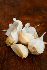 Cloves of garlic on a dark chopping board