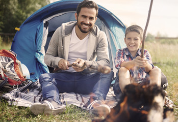 Father and his son spending time together on camping.