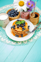 Stack of pancakes on wooden background