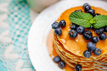 Stack of pancakes on wooden background