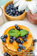Stack of pancakes on wooden background
