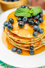 Stack of pancakes on wooden background
