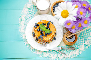 Stack of pancakes on wooden background