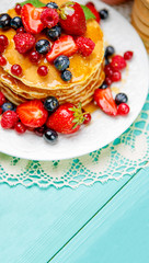 Stack of pancakes on wooden background