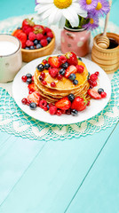 Obraz na płótnie Canvas Stack of pancakes on wooden background