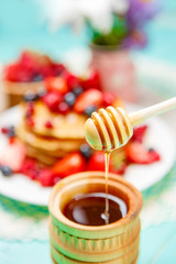 Stack of pancakes on wooden background