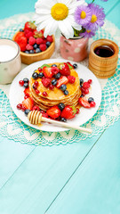 Stack of pancakes on wooden background