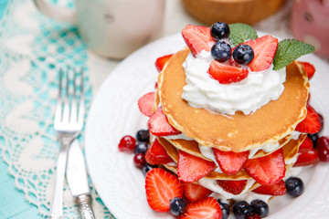 Stack of pancakes on wooden background