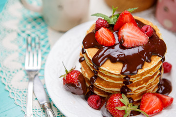 Stack of pancakes on wooden background