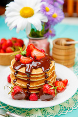 Stack of pancakes on wooden background