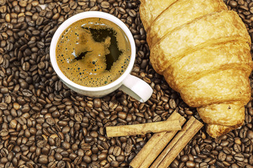 Coffee bean background with cup of fresh hot coffee, three cinam